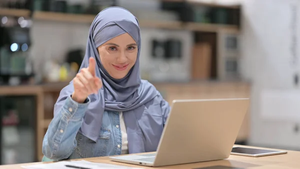 Arab Woman with Laptop Pointing at the Camera