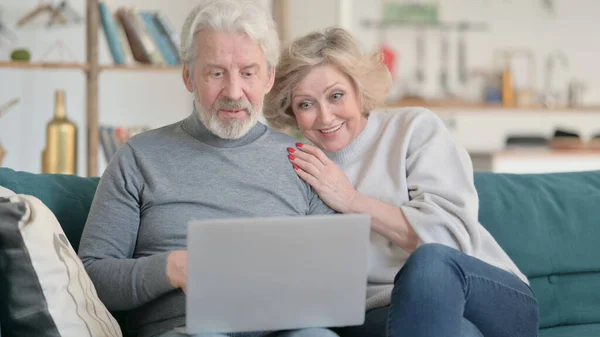 Happy Old Couple Talking on Video Chat on Laptop at Home