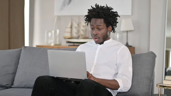 震惊的非洲男人看着笔记本电脑 — 图库照片