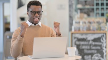 Dizüstü bilgisayarda kutlama yapan başarılı Afrikalı Adam