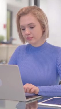 Ofiste dizüstü bilgisayarda çalışırken Genç Kadının Reddedilmesi, dikey video