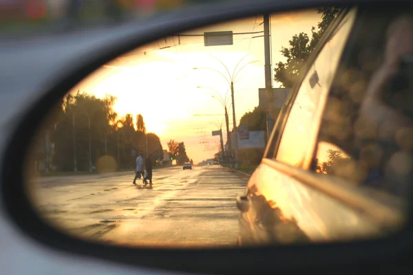Side rear-view mirror in the evening in the city during sunset — Stock Photo, Image