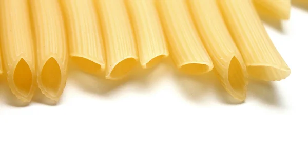 Some raw penne macaroni on white background — Stock Photo, Image