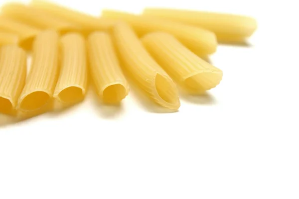 Some raw penne macaroni on white background — Stock Photo, Image