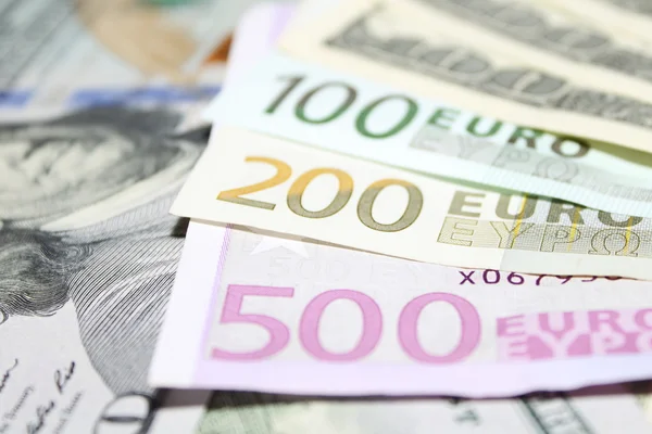 Background of euro and dollar bills. Shallow focus. — Stock Photo, Image