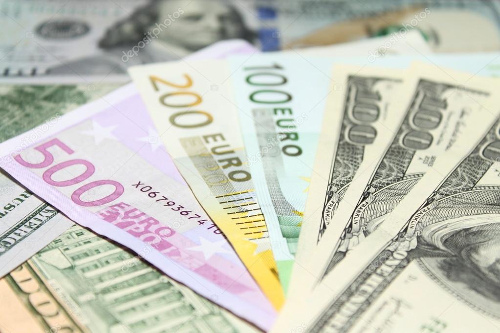 Background of euro and dollar bills. Shallow focus.
