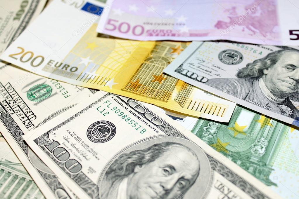 Background of euro and dollar bills. Shallow focus.