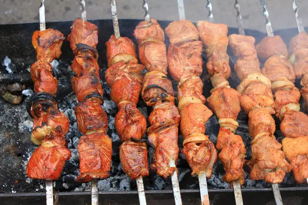Shashlick laying on the grill closeup — Stock Photo, Image