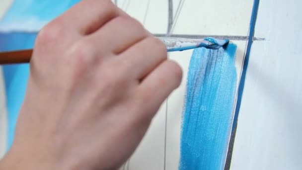 Young blond woman artist paints a picture in blue colors macro Palette — Stock Video