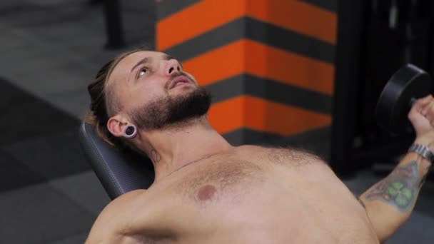 Jeune homme travaille dans la salle de gym Serieux concentré Secoue les bras, pousse l'haltère — Video