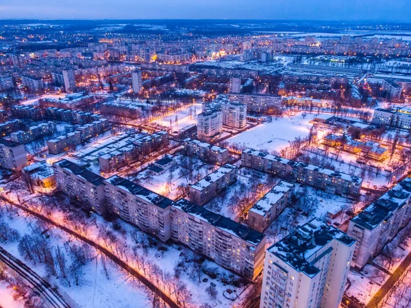 Aerial winter city view with roads, houses, buildings. Helicopter drone shot