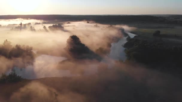 Luchtfoto drone uitzicht op zonsopgang over mistige rivier — Stockvideo