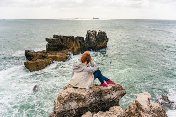 Relax near ocean. Lonely woman admiring the stormy ocean