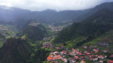 Madeira 'daki Sao Vicente' nin çarpıcı hava manzaralarını keşfetmek, bereketli manzaralar, büyüleyici evler ve doğal güzellikler sergilemek. Huzurlu ortamı ve zengin manzarayı tecrübe edin..