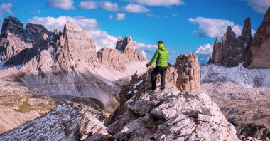 Dağın tepesinden manzarayı uzun yürüyüşe çıkan kimse