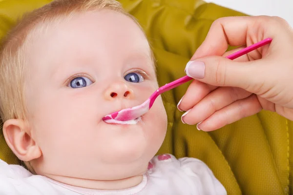 Mother feeds child Stock Picture