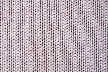 Tekstil arkaplanı için pembe pürüzsüz örülmüş doku.