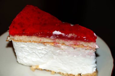 Bir parça peynirli kek ve ahududu jölesi. Yakın çekim.