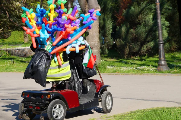 Retired Riding Scooter Colorful Balloons Sale Park — Stock Photo, Image