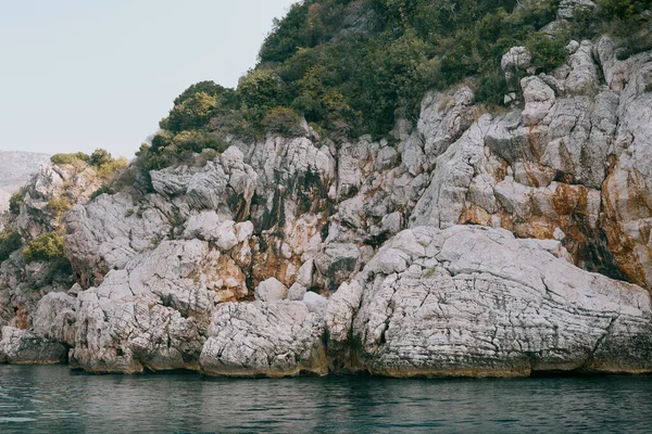 Cerca acantilado del mar, rocas en capas y piedras con agua de mar azul turquesa — Foto de Stock