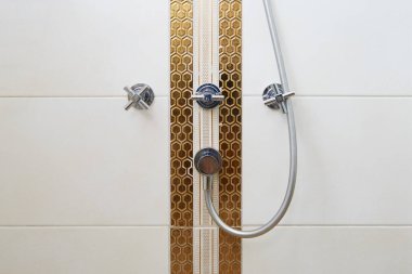 Otel banyosunun duvarında duş musluğu var..