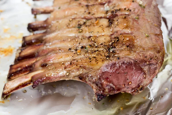 Roast rack of lamb on tinfoil — Stock Photo, Image