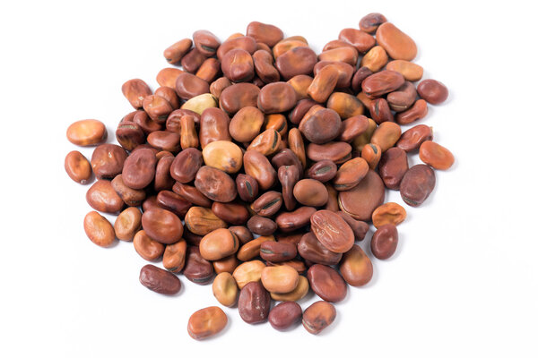 Fava or broad beans in a pile on a white background