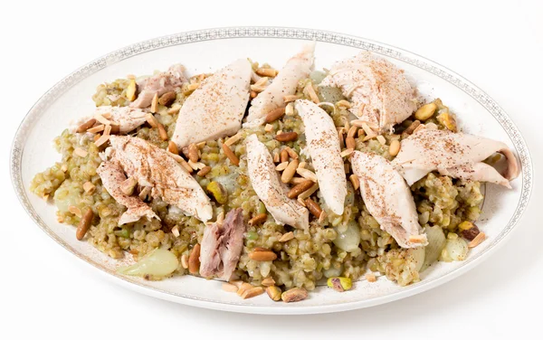 Cinnamon dusted chicken with frikeh and nuts — Stock Photo, Image