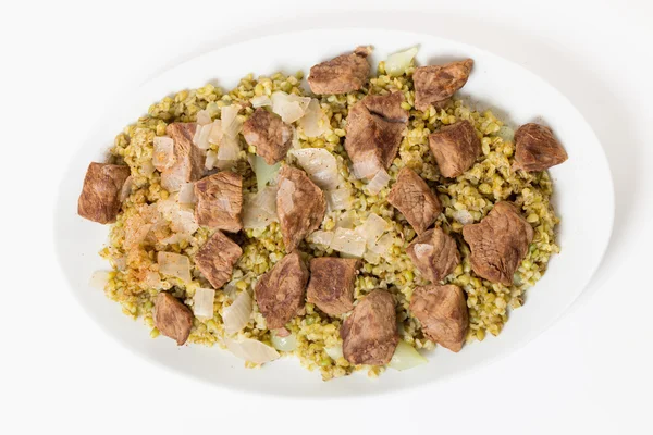 Beef with frikeh serving bowl from above — Stock Photo, Image