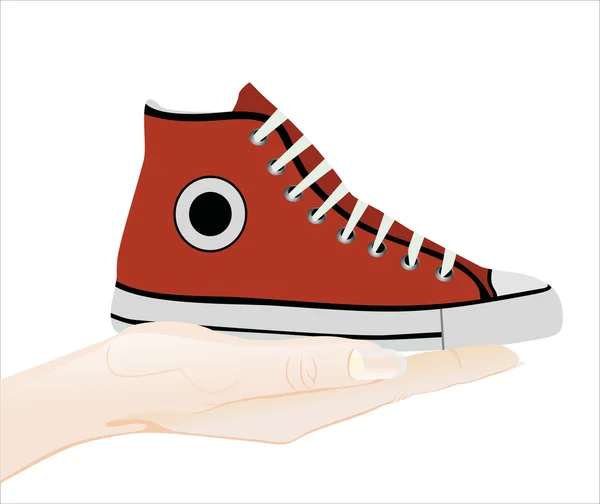 Hand som håller en röd sneaker — Stock vektor