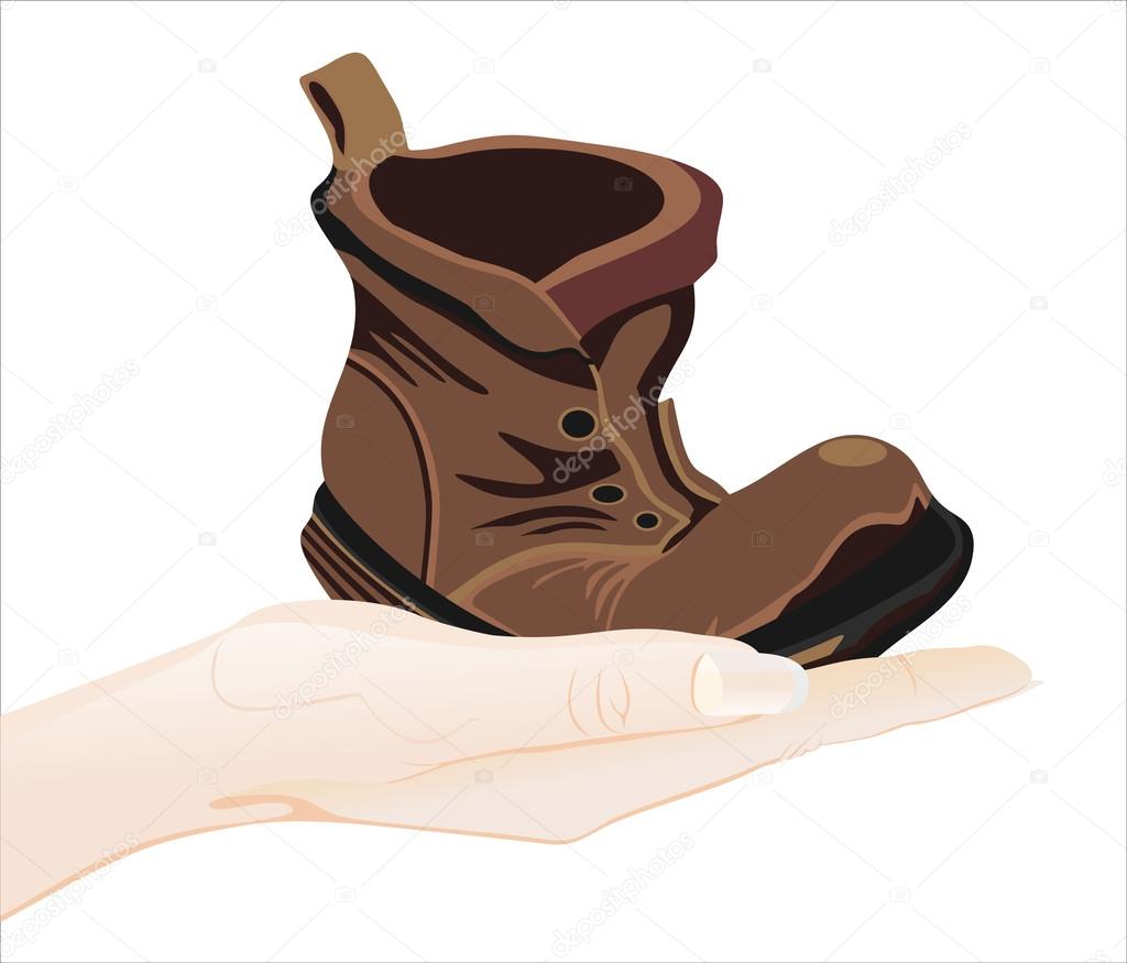 Human hand holding boot