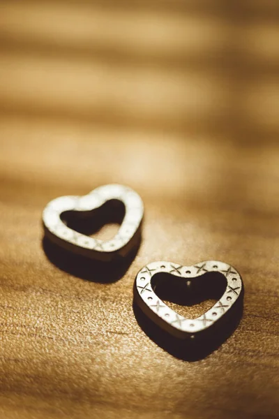Two Metal Hearts Sunny Wooden Table Royalty Free Stock Photos