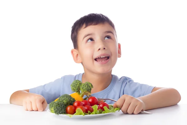 Мальчик ест овощи Лицензионные Стоковые Изображения