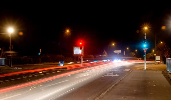 Night city, roadway , lighting street lights blurred traces of headlights of passing cars