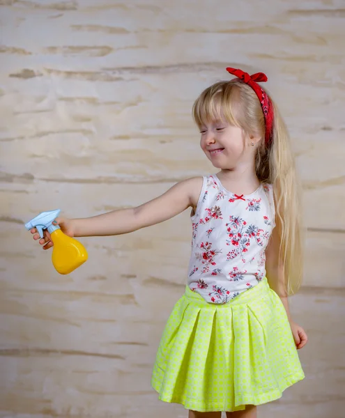 Cute girl using spray bottle — Stock Photo, Image