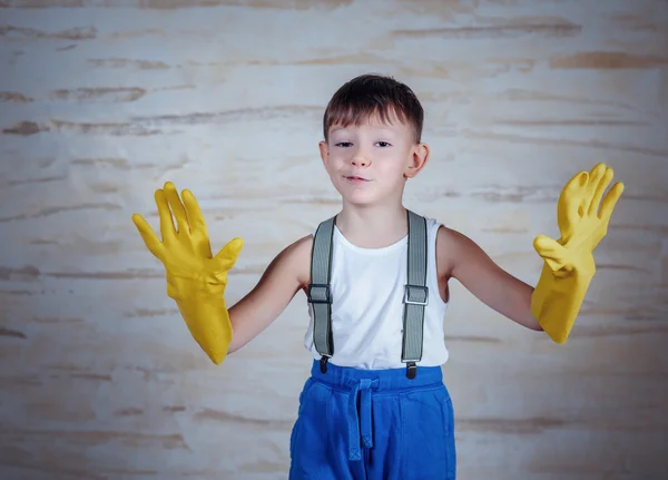 Cute boy in oversized rubber gloves — Stock Photo, Image
