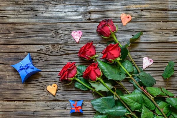 Τριαντάφυλλα και σχήματα καρδιάς πέρα από το ξύλινο υπόβαθρο — Φωτογραφία Αρχείου
