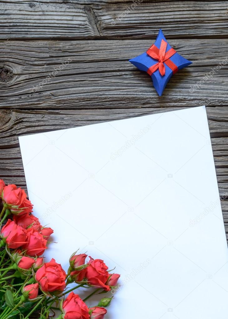 Blank paper with gift box and rose bundle