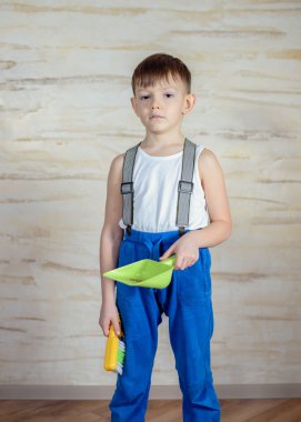 Child using toy broom and dustpan