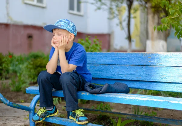 Bored little boy sitting waiting — Stockfoto