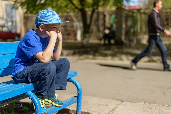 Patient young boy sitting waiting — Stock Photo, Image