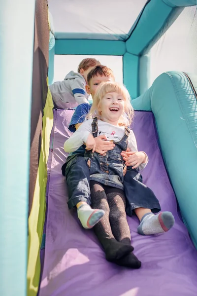 Niños bajando inflable tobogán hinchable — Foto de Stock