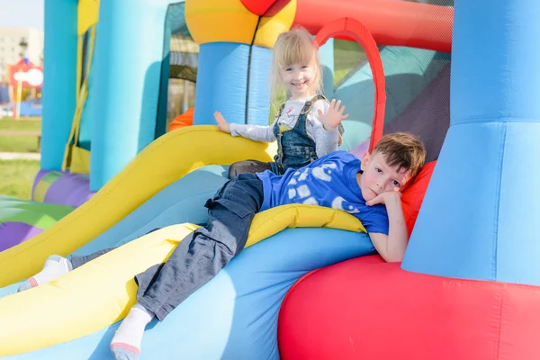 Brother and sister on inflatable castle Stock Picture