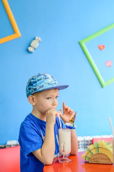 Trendy excited little boy enjoying a milkshake — Stock Photo, Image