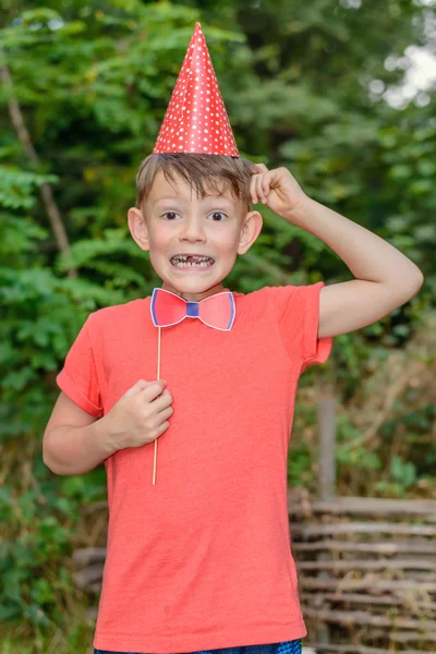 Young boy clowning with photo booth props — Stock Photo, Image