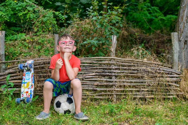 Funny young boy playing with photo booth props — Stock Photo, Image