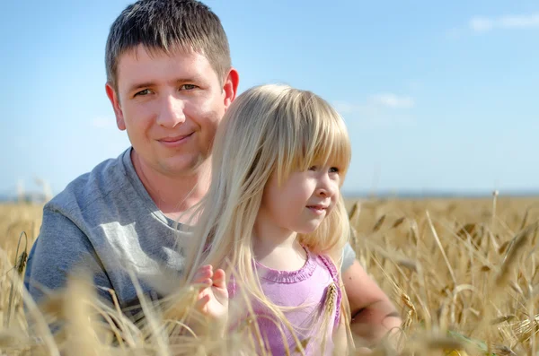 Cute little girl with her father in a wheat field — Stock Photo, Image