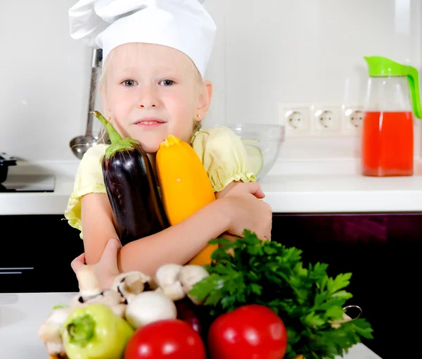 Smiling happy little girl in a cooks uniform — Stock Photo, Image