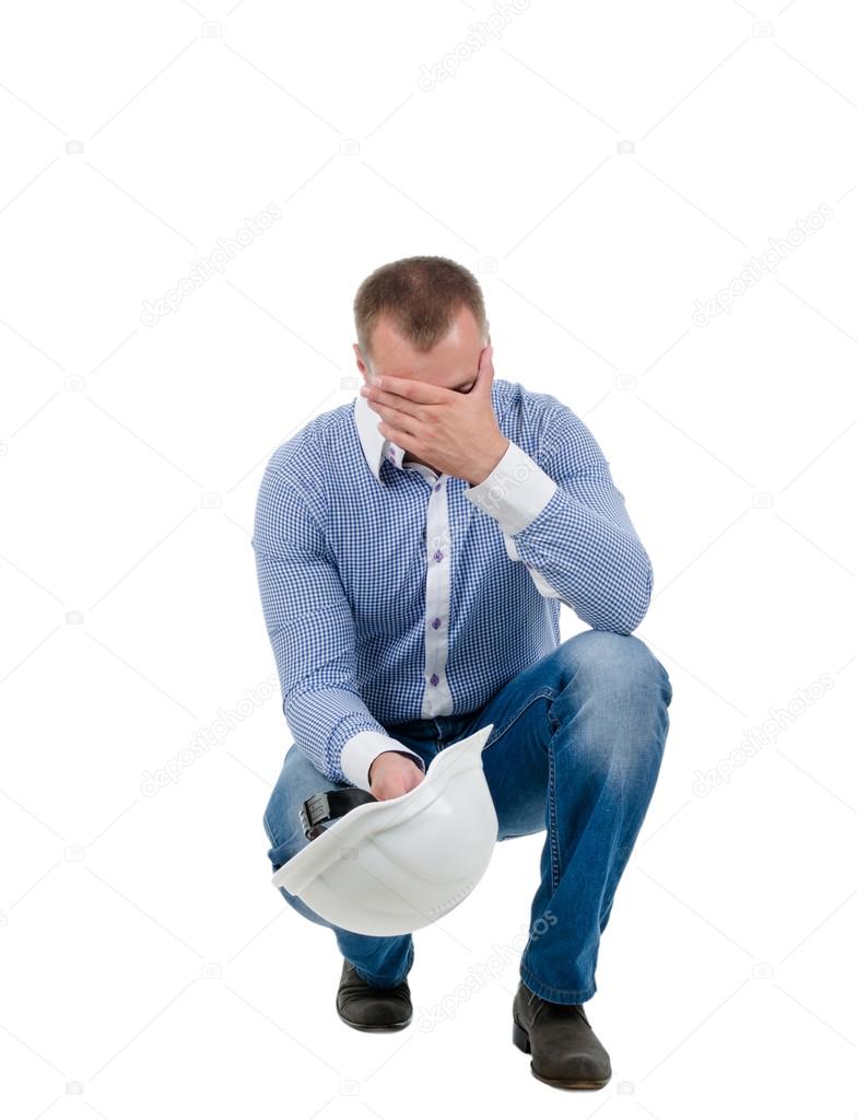 Worried engineer holding his head