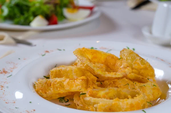 Primo piano di anelli di cipolla fritti in ciotola — Foto Stock